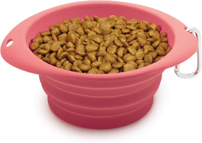 Pink silicone pet bowl filled with dog food on a white background