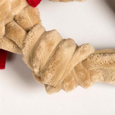 Close-up of a textured beige dog toy with knot on a white background