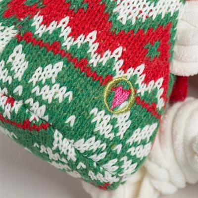Close-up of a knitted item with green, red, and white pattern on a white background