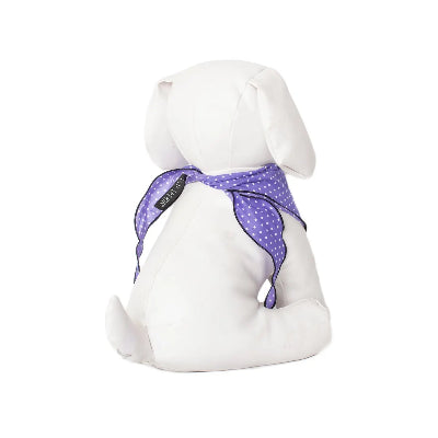 White dog toy with a purple polka dot bandana on a white background