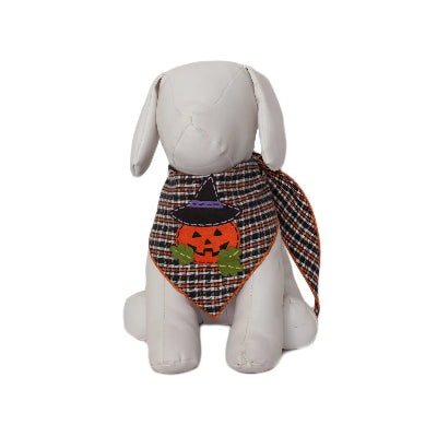 White dog wearing a Halloween-themed plaid bandana with a jack-o'-lantern design on a white background.