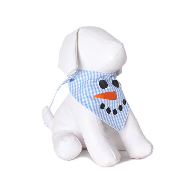 White dog mannequin with a blue checkered snowman face bandana and orange nose on a white background