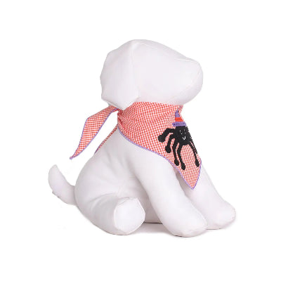 White dog mannequin with an orange checkered scarf featuring a black spider design on a white background