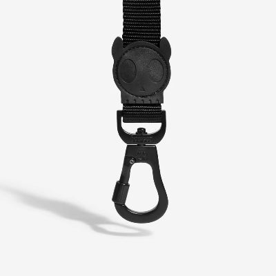 Black dog leash with clip on a white background