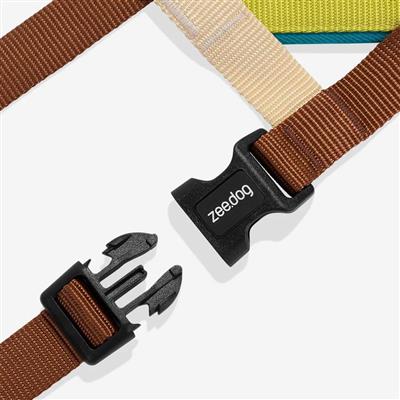 Brown dog harness with black clip and 'zeedog' branding on a white background