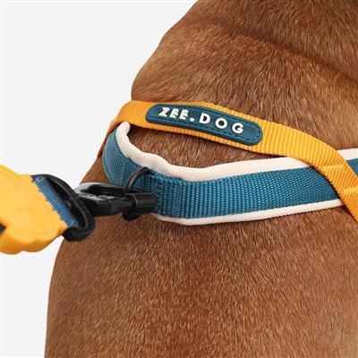 Dog harness with a visible brand label on a dog's neck against a white background