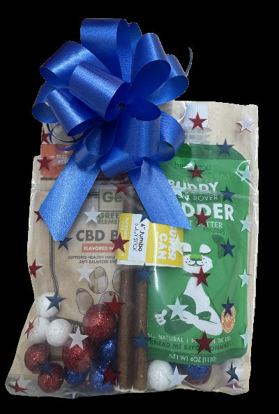 Gift package with a blue bow, including a bag of treats and a green label on a black background.
