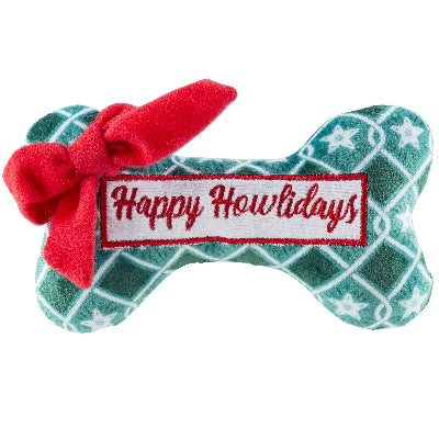 Dog toy shaped like a bone with a red bow and 'Happy Howlidays' label on a white background