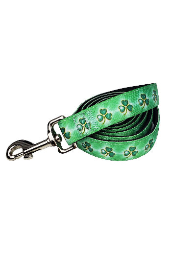 Green dog leash with shamrock patterns on a white background