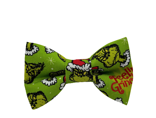 Green dog bow tie featuring the Grinch on white background.