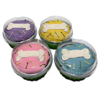 Four colorful dog cupcakes with bone accents on a white background