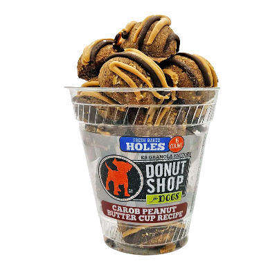 Clear container with donut-shaped dog treats on a white background