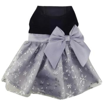 Dog dress with black top and gray skirt with snowflake pattern and large bow on a white background