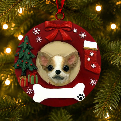 A personalized Christmas pet ornament shaped like a red wreath hanging on a Christmas tree. The ornament features a photo cutout of a Chihuahua dog, surrounded by festive details including a red bow, white snowflakes, a green Christmas tree, a red stocking, a white bone, and a blank white space for personalization.