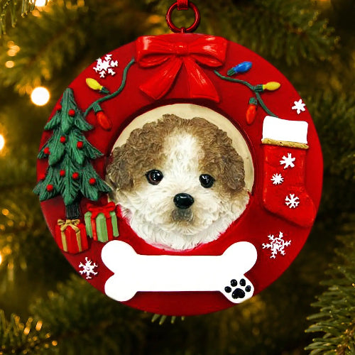 A circular red Christmas ornament hanging on a Christmas tree, featuring a custom photo cutout of a Shih Tzu with a puppy cut surrounded by festive decorations including a red bow, miniature Christmas tree, stockings, ornaments, and a white bone at the bottom.
