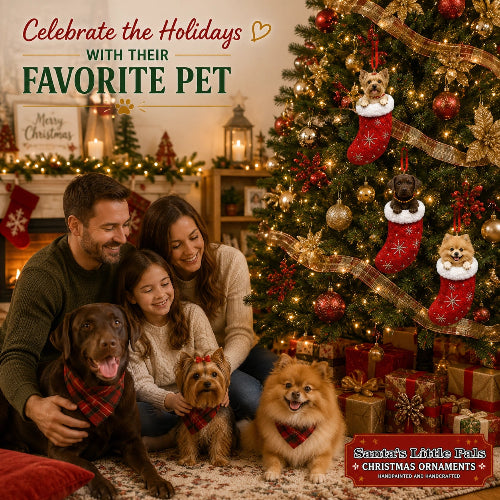 Family with 3 dogs sitting on patterned rug with Christmas tree and ornaments and decorated fireplace mantle in background.