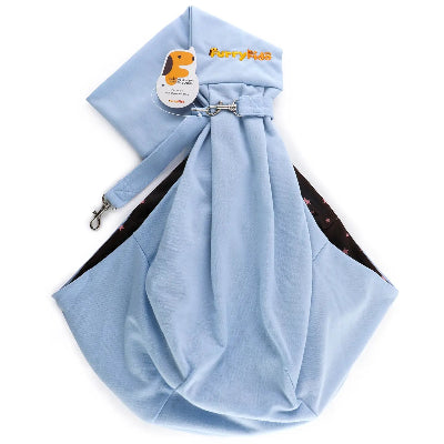 Blue pet sling with brand tag on a white background