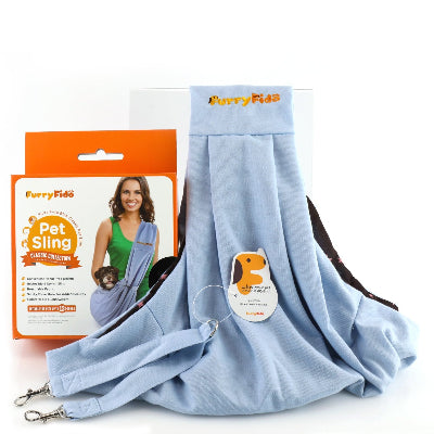 A light blue pet sling carrier shown with its retail packaging box. The packaging features the FurryFido brand and an illustration of a woman holding a small dog in the sling.