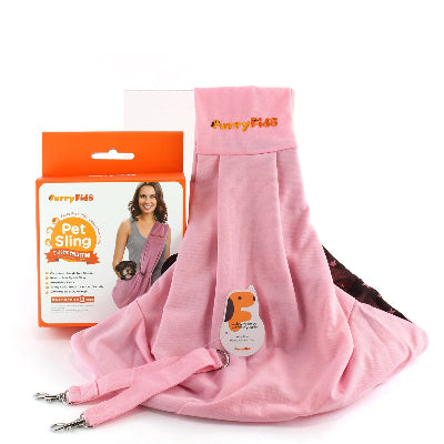 Pink pet sling carrier shown with its orange and white retail packaging box on a white background. The fabric carrier has metal clips at the bottom and a small dog-shaped sticker.