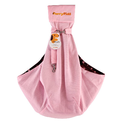 A pink fabric pet carrier bag with a top strap and metal clip, featuring the 'FurryFido' brand name embroidered on the top strap. A hangtag with a cartoon dog is attached, and the bag is shown against a plain white background.