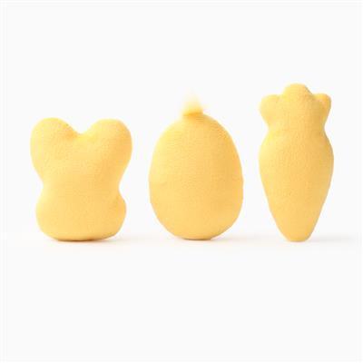 Three yellow bunny, egg & carrot shaped toys on a white background