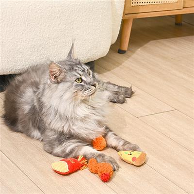 Cat lying on a wooden floor with a toy next to it