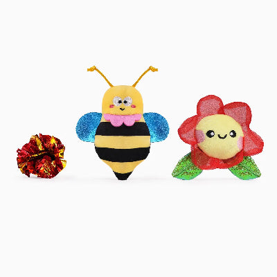 Toy bee, flower, and ball on a white background