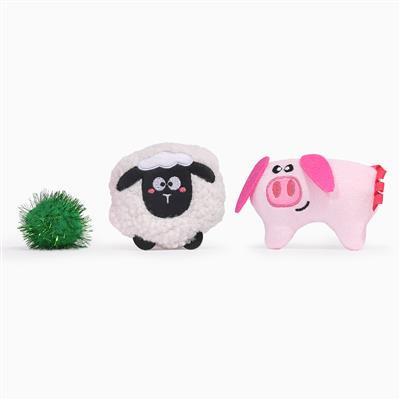 Toy sheep, green ball, and toy pig on a white background
