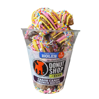 Clear container with dog treats labeled 'Donut Shop for Dogs' on a white background