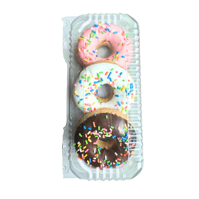 Three donuts with different flavors and sprinkles in a clear plastic container on a white background