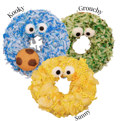 Three donuts resembling Cookie Monster from Sesame Street, labeled 'Kooky', 'Grouchy', and 'Sunny'.