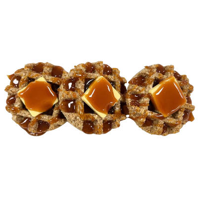 Three waffle-like treats with caramel and butter looking squares on a white background