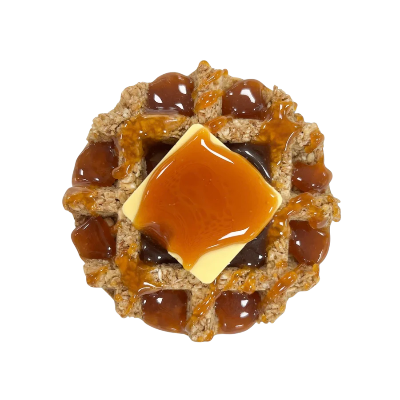Waffle treat with caramel with a square of yogurt butter on a white background