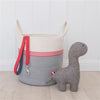 Gray Dinosaur Dog Toy sitting beside rope toy basket