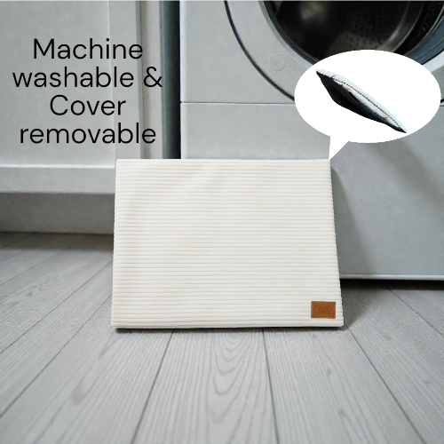Pet mat on gray wood floor with washing machine in background 