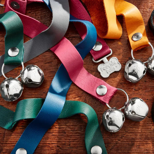 PoochieBells Premium Full Grain Leather Dog Doorbells in various colors on wood background
