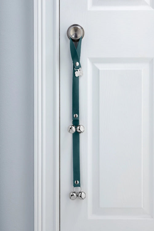 EvergreenPoochieBells Premium Full Grain Leather Dog Doorbells hanging on doorknob of white door