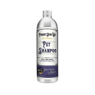 A silver bottle of Project Sudz pet shampoo with a white and purple label, set against a plain white background.