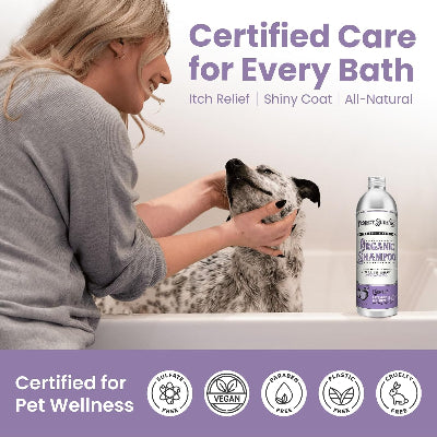 A woman gently bathes a black-and-white spotted dog in a white tub while a bottle of Project Sudz Organic Shampoo sits on the tub edge. Large text reads 'Certified Care for Every Bath' with benefits like itch relief and shiny coat.