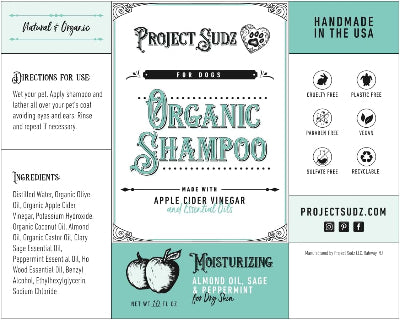 Project Sudz Organic Shampoo for Dogs packaging card, featuring a white central panel with teal and black lettering, flanked by light teal side panels with product information, ingredients, and certifications.