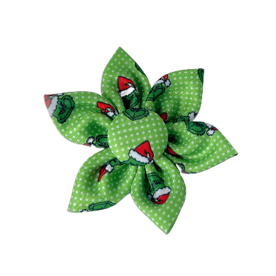 Green fabric flower with Grinch pattern on a white background