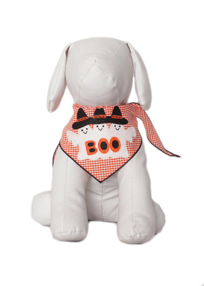 A white plush stuffed dog wearing a Halloween-themed bandana with orange and white gingham, black witch hats, and the word 'BOO' in orange.