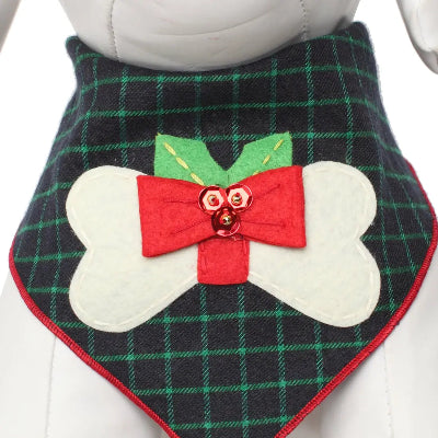 Plaid dog bandana with a red bow and white bone design on a mannequin.