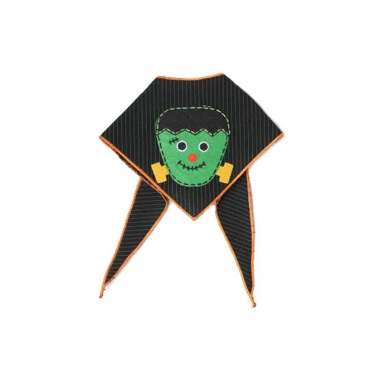 A Halloween-themed triangular bandana or bib with a Frankenstein monster face applique on a black pinstriped fabric, featuring orange trim and yellow accents, shown on a plain white background.