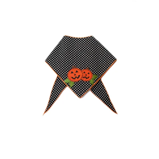 A black pet bandana with white polka dots, featuring two embroidered orange jack-o'-lantern pumpkins with green leaves at the center and orange trim along the edges.