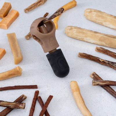 Dog chew treat with a crimping tool on a light surface
