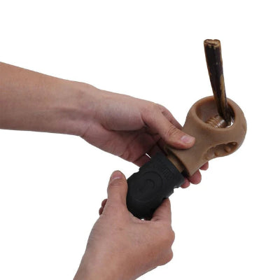 Person holding a tool with a wooden handle and black grip on a white background