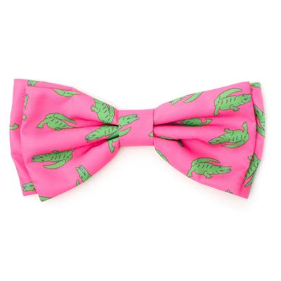 Pink cat or dog bow tie with green alligators on white background