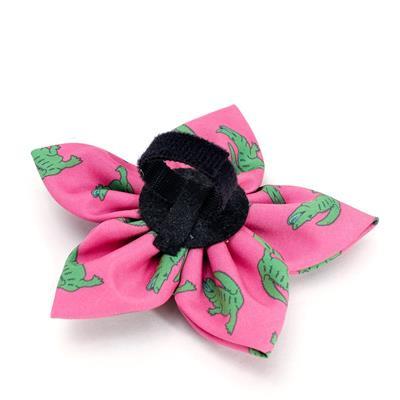 Pink flower-shaped collar flower with green alligator patterns on a white background
