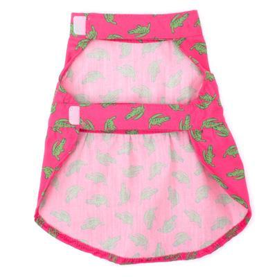 Pink pet dress with green patterns on a white background
